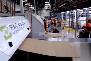 Packsize workers using a machine to make boxes